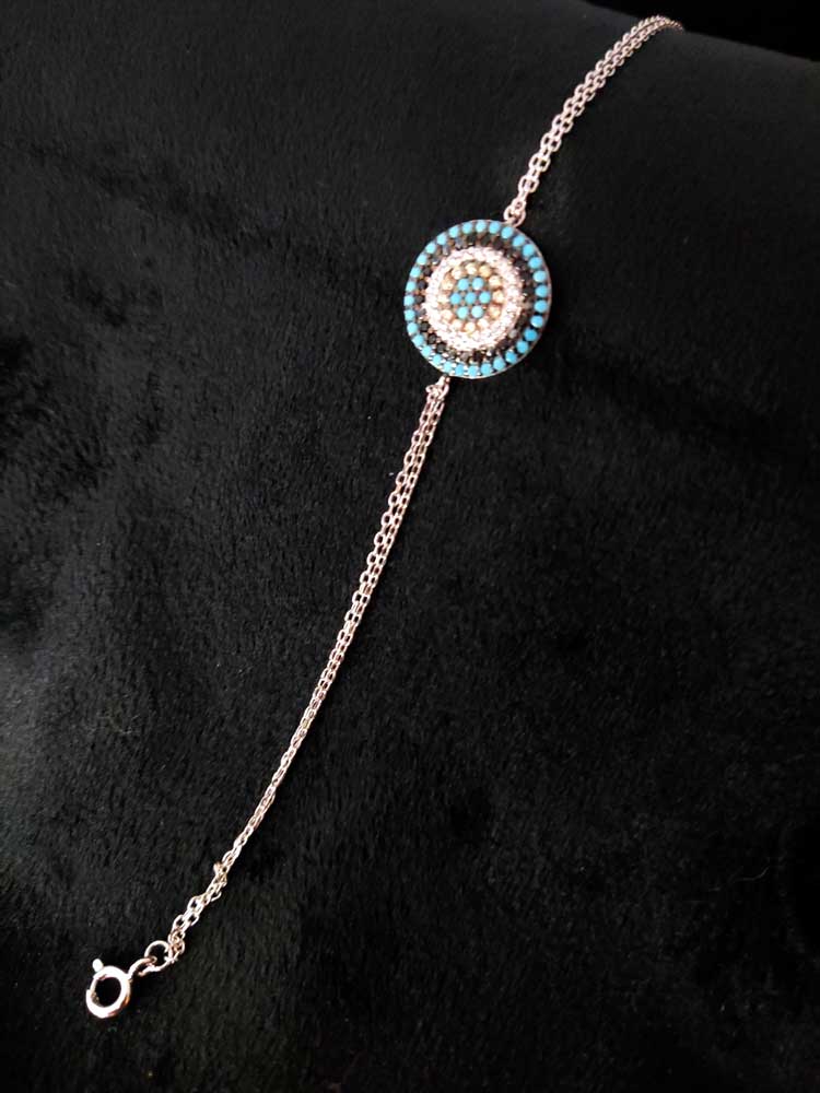 Detailed view of a 1.4 cm sterling silver Evil Eye pendant with turquoise and crystal stones, hallmarked and expertly made, ideal for stylish layering.