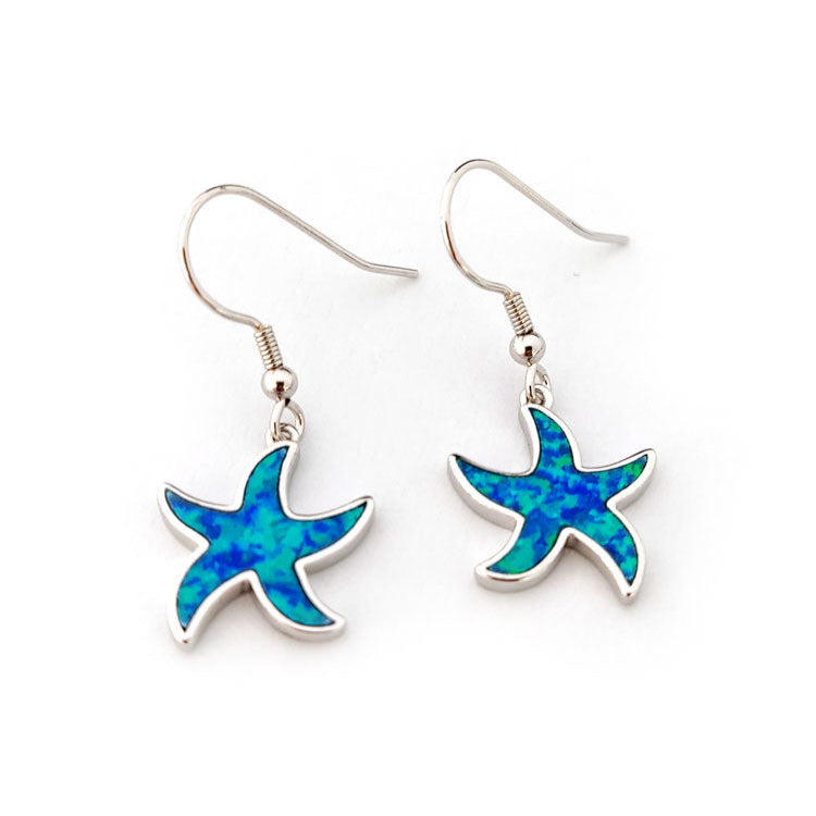 Starfish-shaped silver earrings with blue opal design on a white background