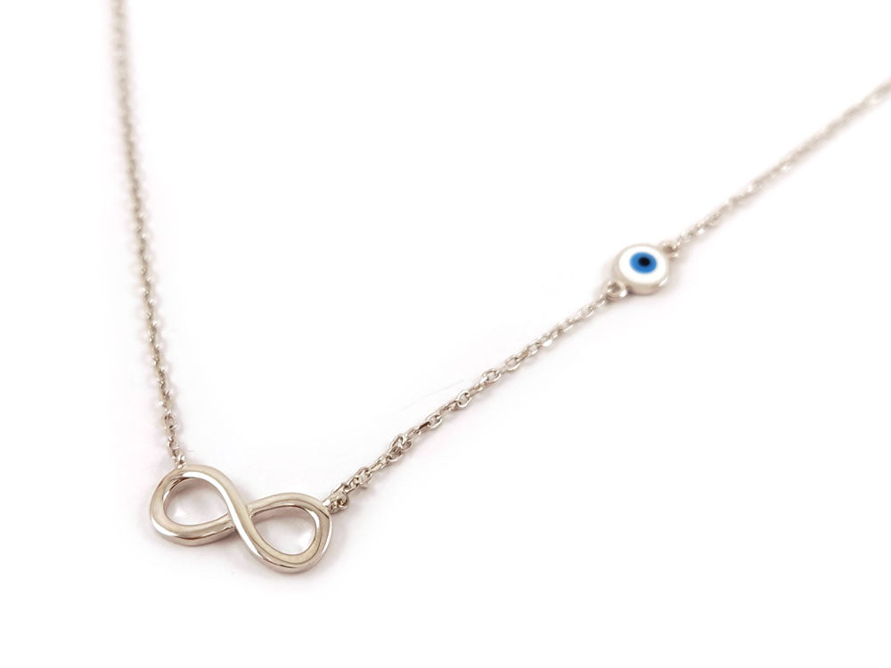 Elegant sterling silver 925 necklace with infinity and evil eye pendants on a white background. The infinity symbol measures 13 x 6 mm, and the evil eye is 5 mm. Adjustable chain length: 40-43 cm. Hallmark 925. Made in Greece. Free shipping worldwide.