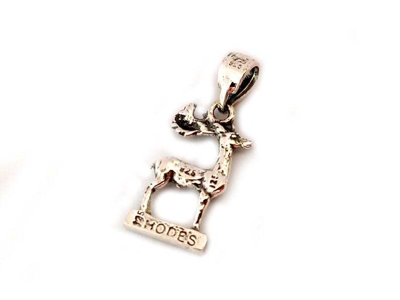 A Greek silver pendant that depicts the Deer Of Rhodes.