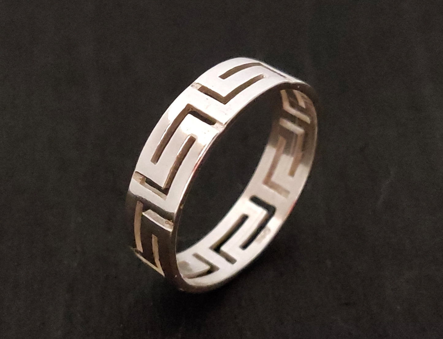 Greek key ring made of sterling silver 925 on black background.