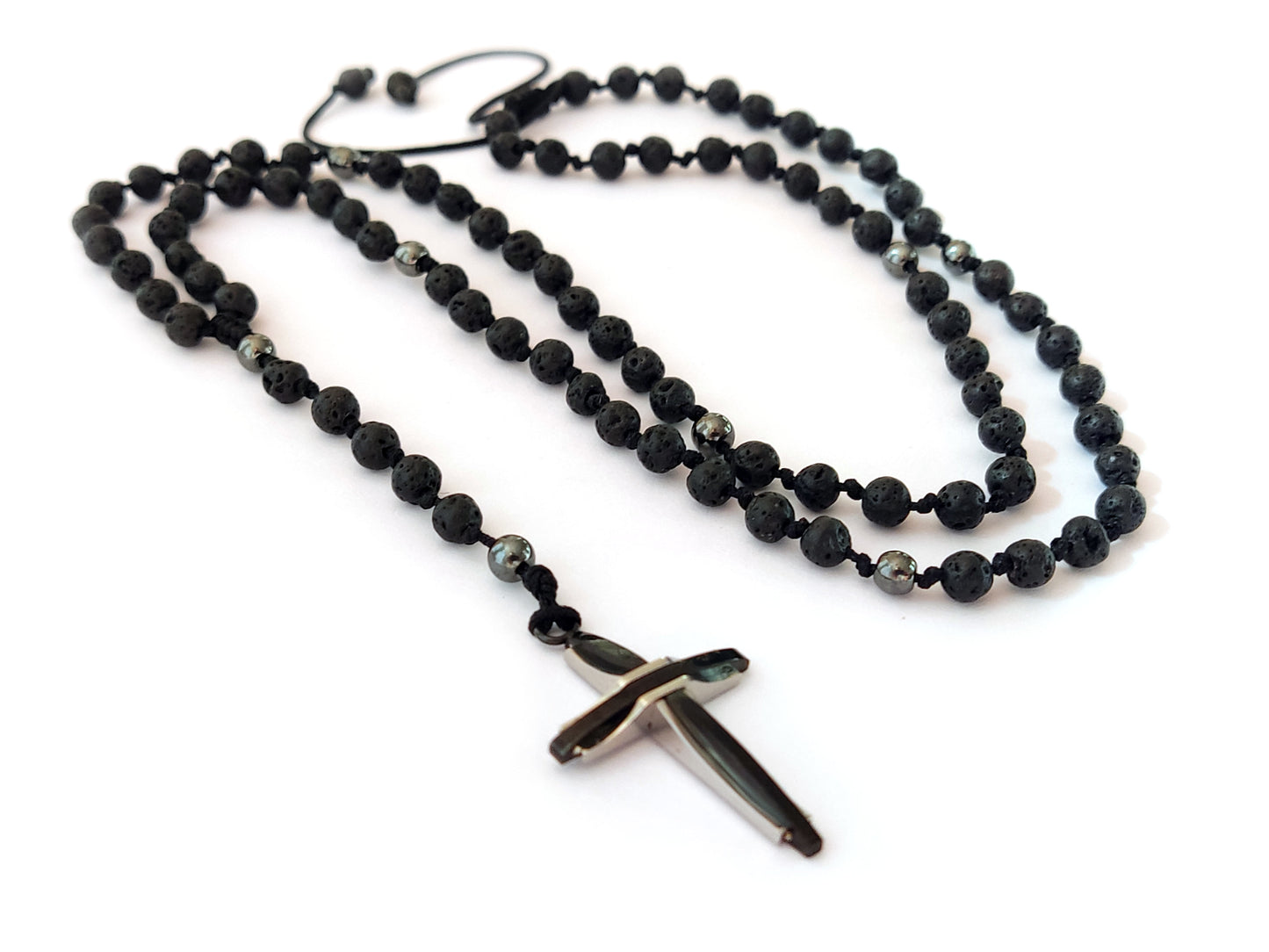 Elevate your style and spirituality with our Handmade Rosary Necklace. Meticulously crafted in Greece, it boasts Natural Black Lava and Hematite Stones (4mm) for a touch of nature's elegance. The Stainless Steel Cross (30 x 20 mm) adds a meaningful symbol, while the adjustable length ensures a comfortable fit between 55 - 70 cm. Embrace the artistry of Greece and enjoy Free Shipping on this exquisite piece.