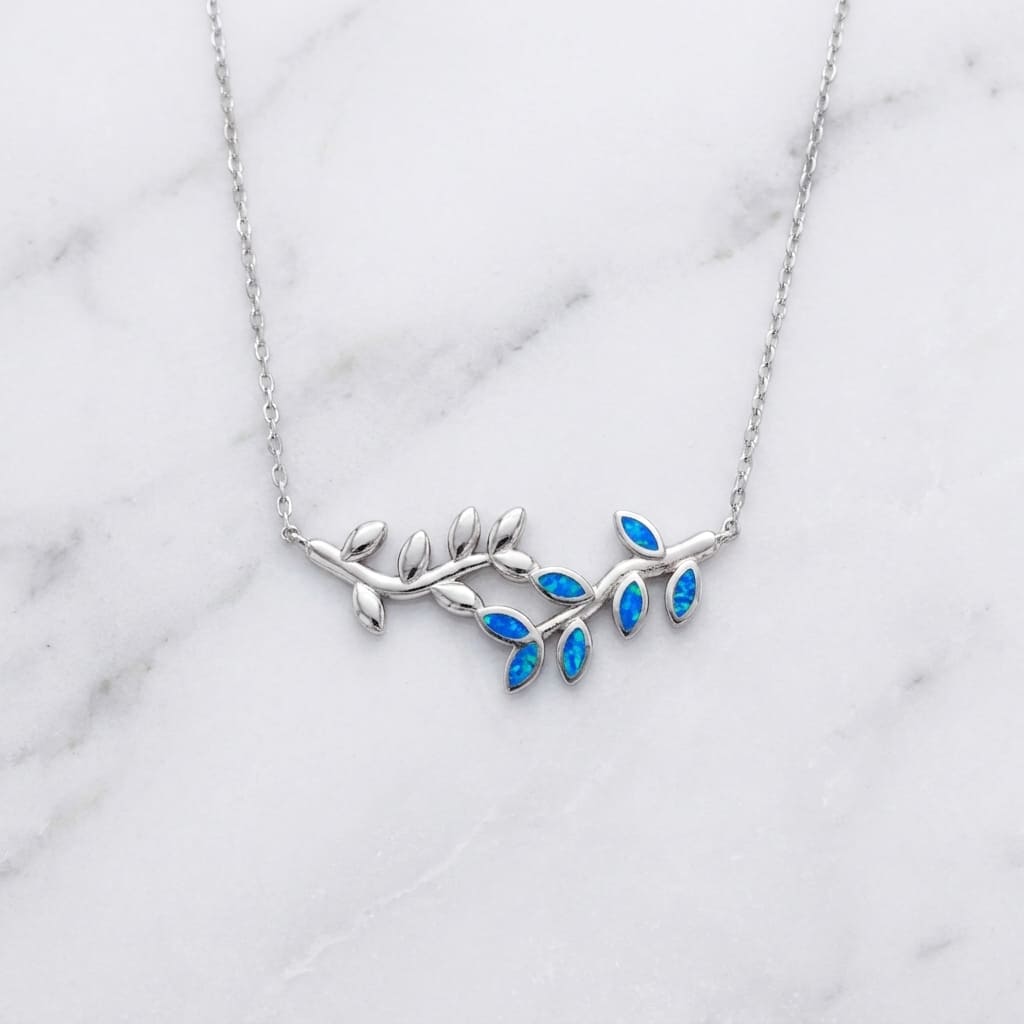 Greek Silver necklace with blue stones on a marble surface