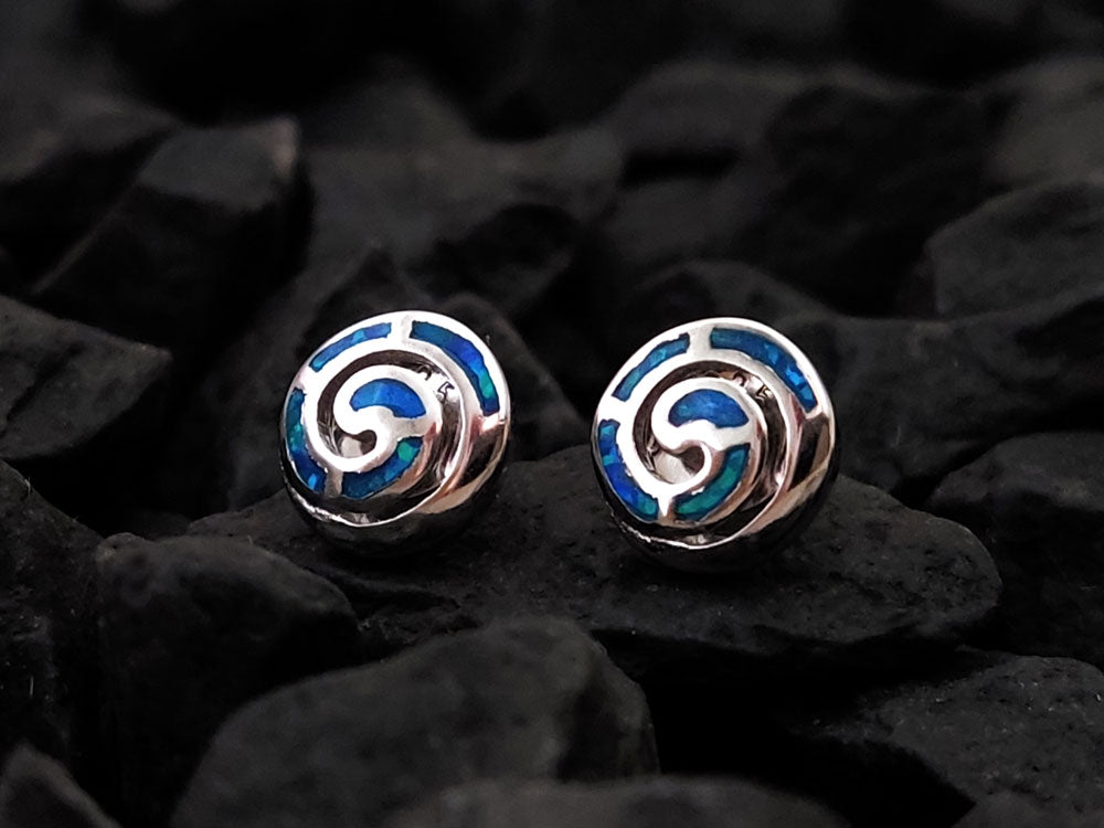 Greek spiral round silver stud earrings with blue opal stones placed on black stones measuring 9 mm or 0.35 inches.