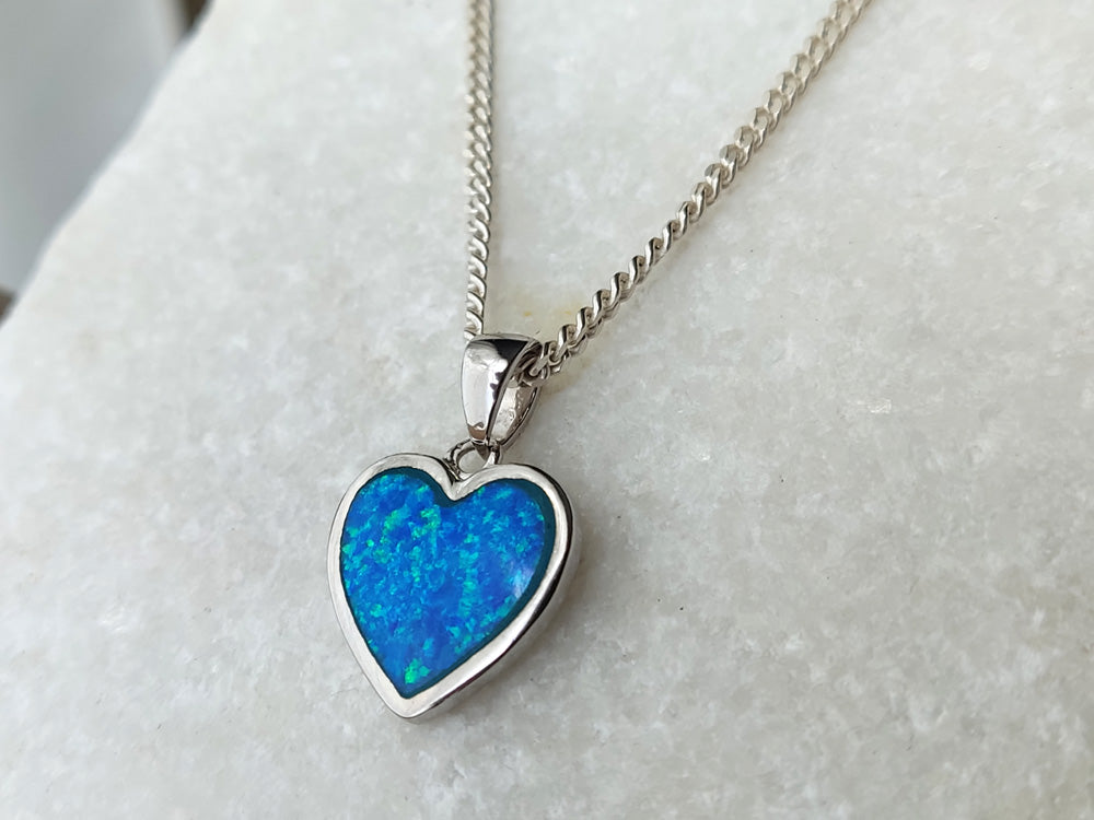 Close up blue opal heart pendant