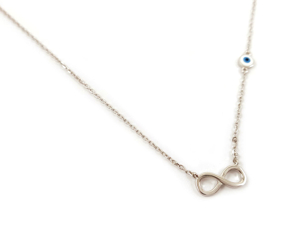 Sterling silver 925 infinity necklace with evil eye design on a white background. Infinity pendant measures 13 x 6 mm, evil eye 5 mm. Adjustable chain between 40 and 43 cm. Made in Greece with hallmark 925. Free shipping worldwide.