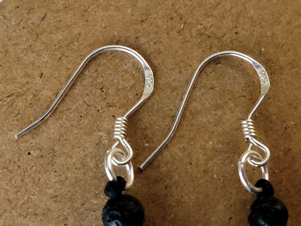 "Elegant Greek-made dangle earrings with volcanic lava stones and sterling silver hooks, in a handcrafted design measuring 40mm (1.57”) long and 10mm (0.39”) wide."