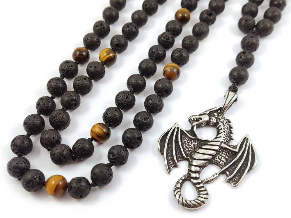 Close-up of handcrafted necklace with natural Lava Stones, Tiger’s Eye, and a stainless steel dragon pendant.