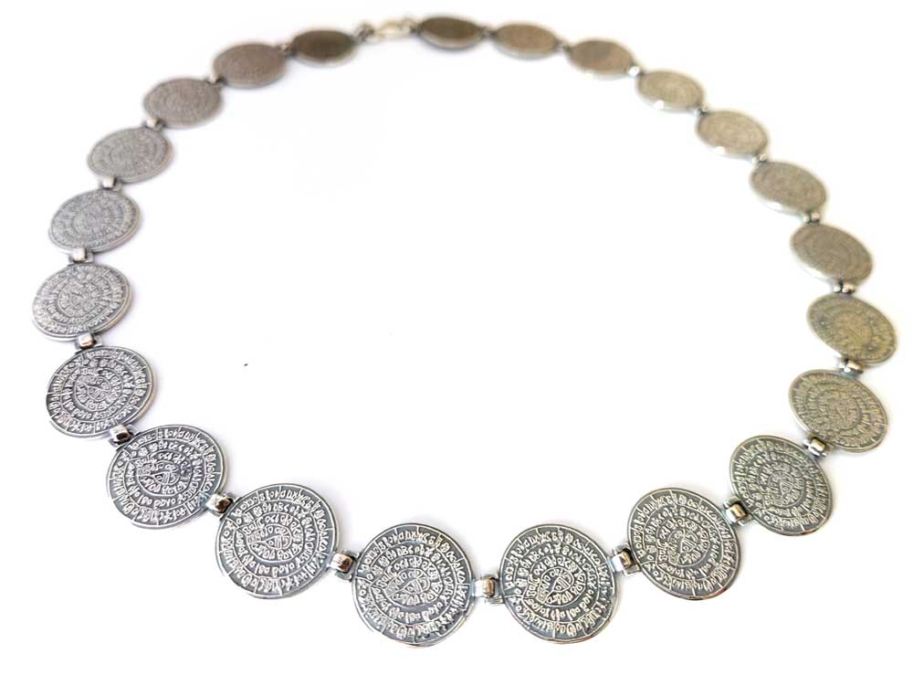 A gleaming Sterling Silver 925 Necklace adorned with a beautifully detailed Ancient Greek Minoan Phaistos Disc pendant, showcasing exquisite craftsmanship and cultural significance.