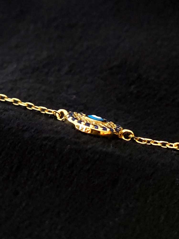 Handcrafted Evil Eye Nazar bracelet with gold-plated sterling silver, dark blue crystals, perfect for daily wear or layering.