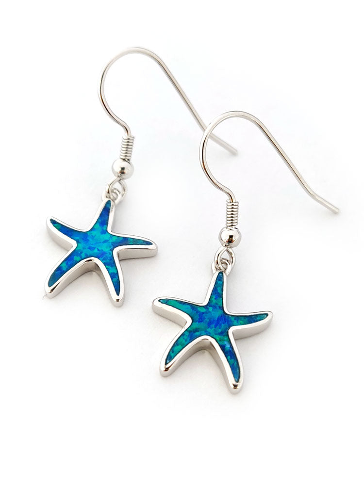 Starfish-shaped earrings with blue centers on a white background