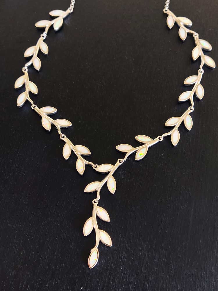 Gorgeous silver Greek necklace with white opal stones in the shape of leaves.