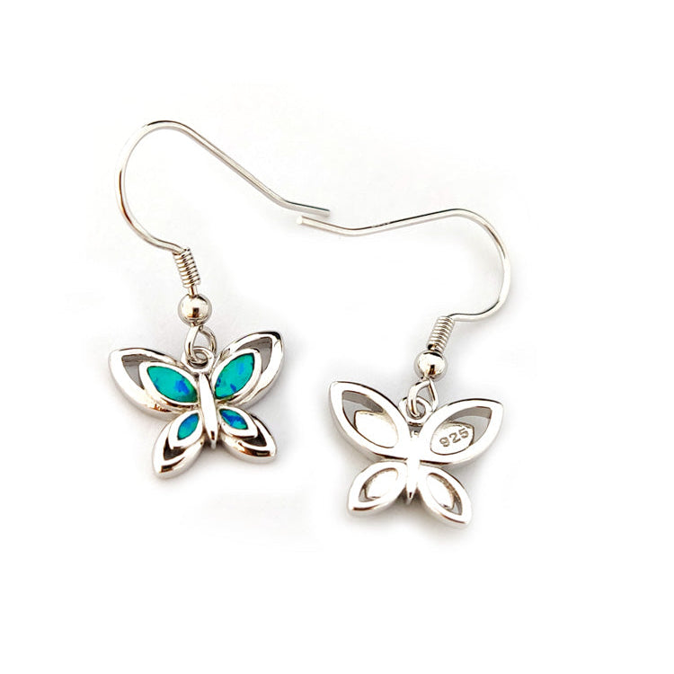 Butterfly-shaped earrings with blue accents on a white background