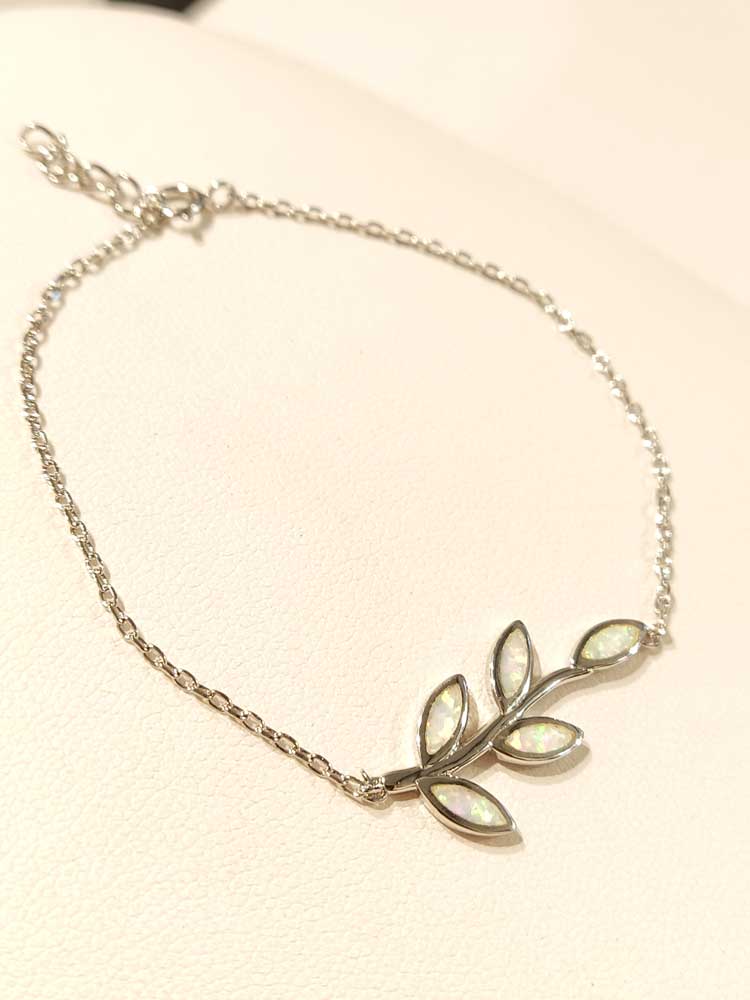 Silver bracelet made in Greece with white opal stones in the middle in leaves shape. The bracelet is adjustable.