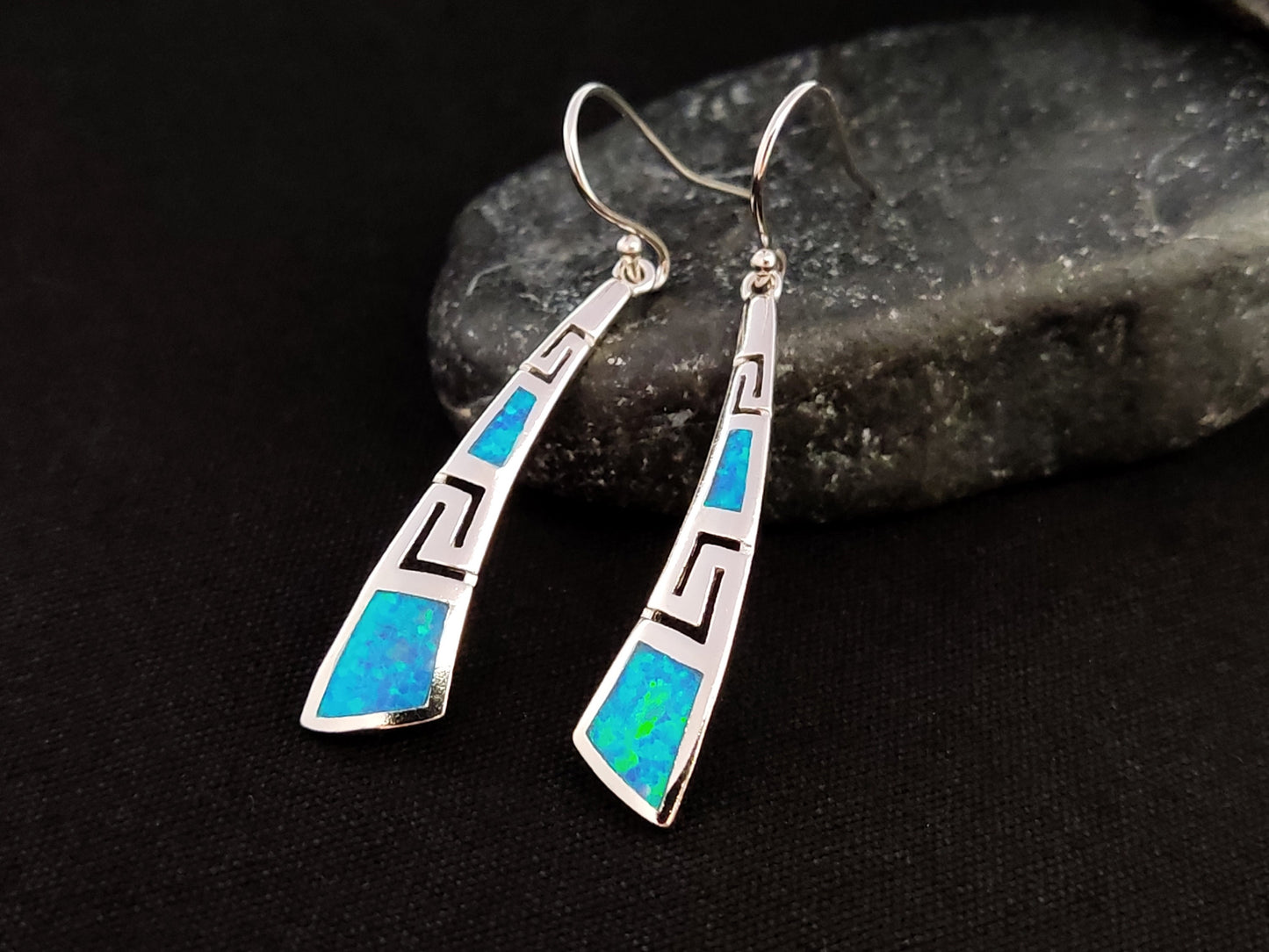 Greek Key opal earrings made of Sterling Silver 925 on a black rock with black background.