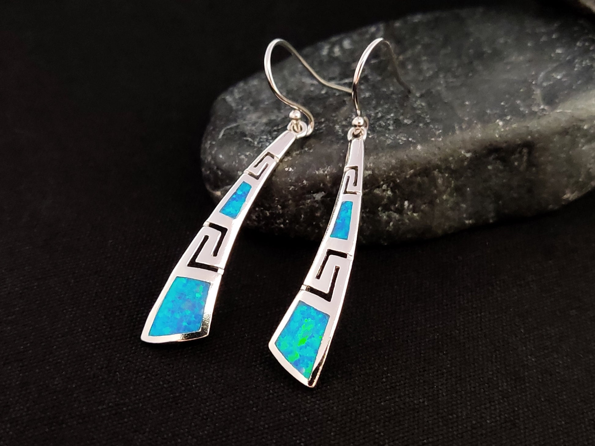 Greek Key opal earrings made of Sterling Silver 925 on a black rock with black background.