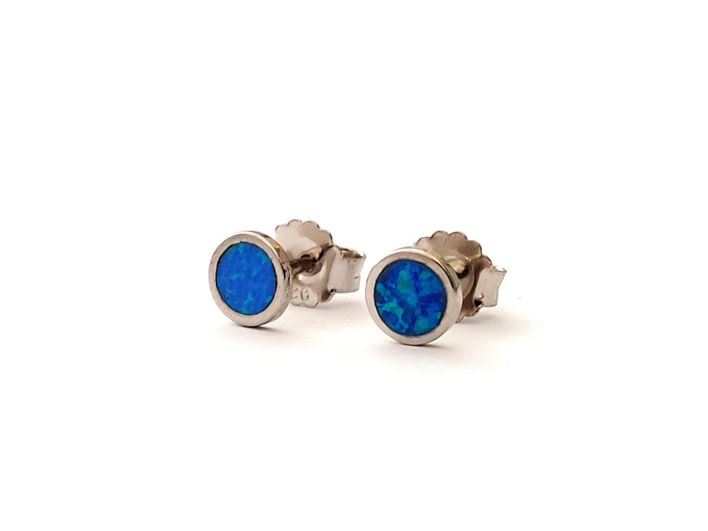 Round opal silver Greek earrings on white background.