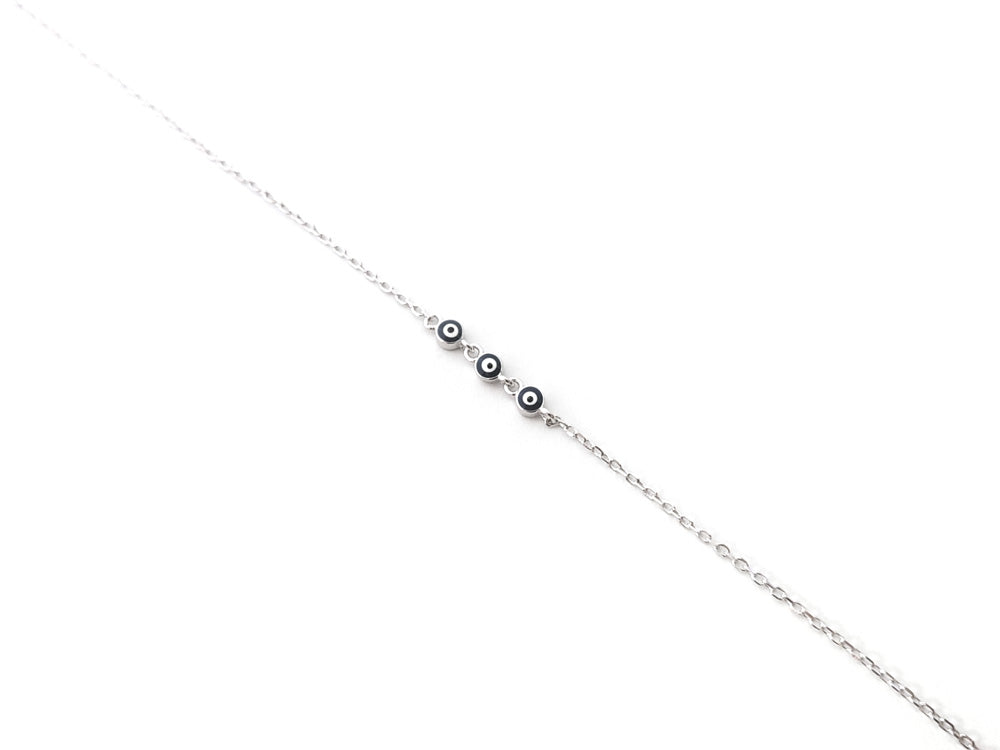 "Adjustable sterling silver mati bracelet with three evil eye charms – close-up detail"

