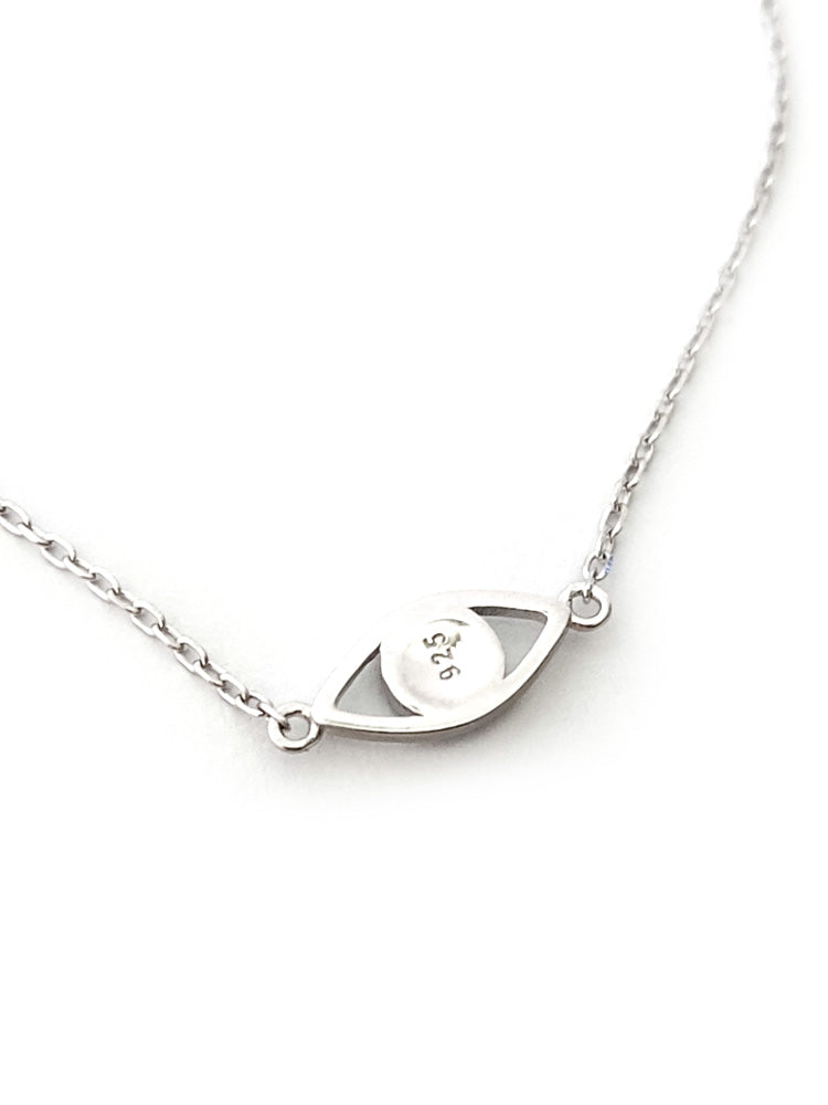 "Close-up of mati evil eye charm on polished silver bracelet – Greek protection jewelry"

