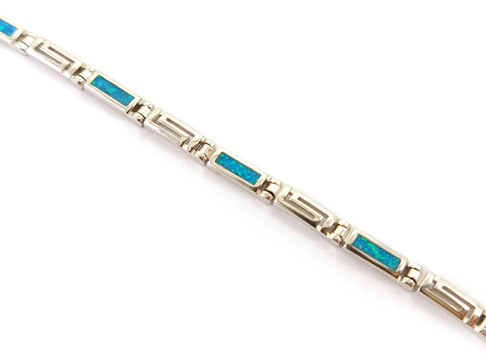 "Handmade Sterling Silver bracelet with Greek Key motif, shimmering blue opals, adjustable length 18.5-21 cm, 3mm width, hallmarked 925 for quality."






