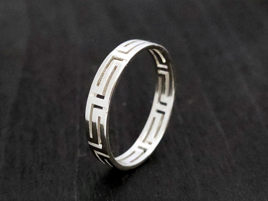 Silver ring with the Greek Key measuring 4mm on black background.