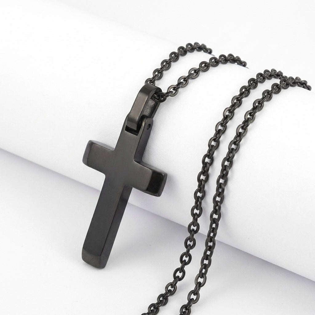 Close up of black cross pendant detail