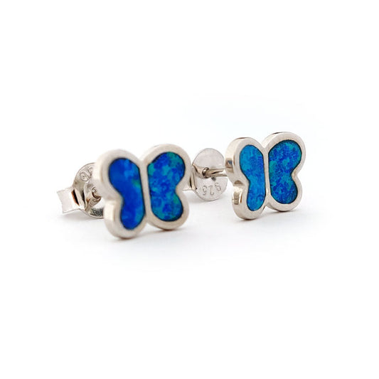 Butterfly-shaped silver earrings with blue opal inlay on a white background