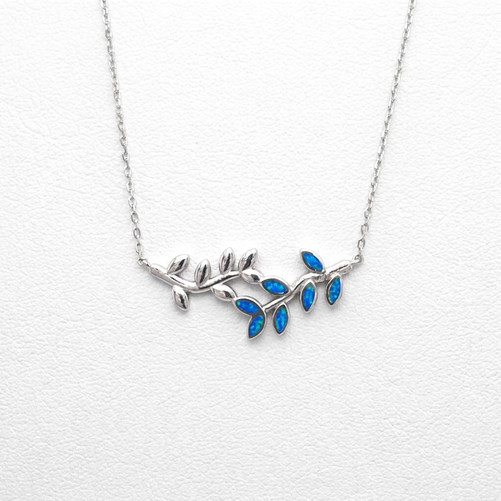 Silver necklace with blue leaf-like pendants on a white background