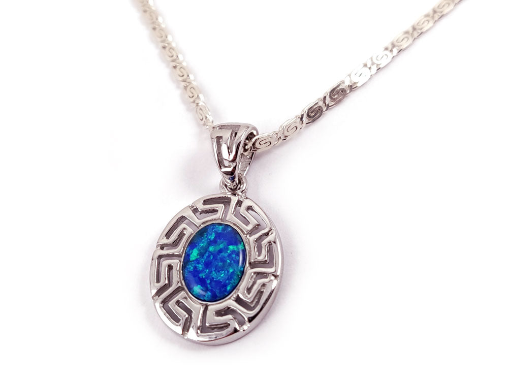 Close-up of blue opal stone in a sterling silver Greek infinity pendant.
