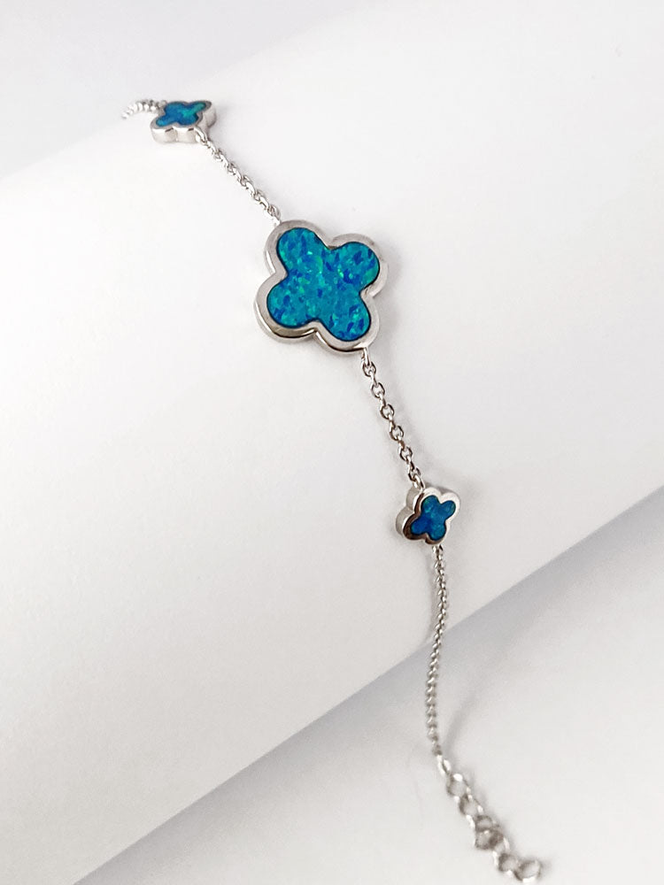 Adjustable sterling silver bracelet with three opal crosses, highlighting the 7–15 mm width and polished finish.