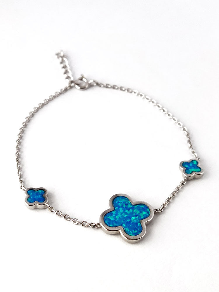 Blue opal cross motif bracelet crafted in 925 sterling silver, shown with its 17–19 cm adjustable clasp.