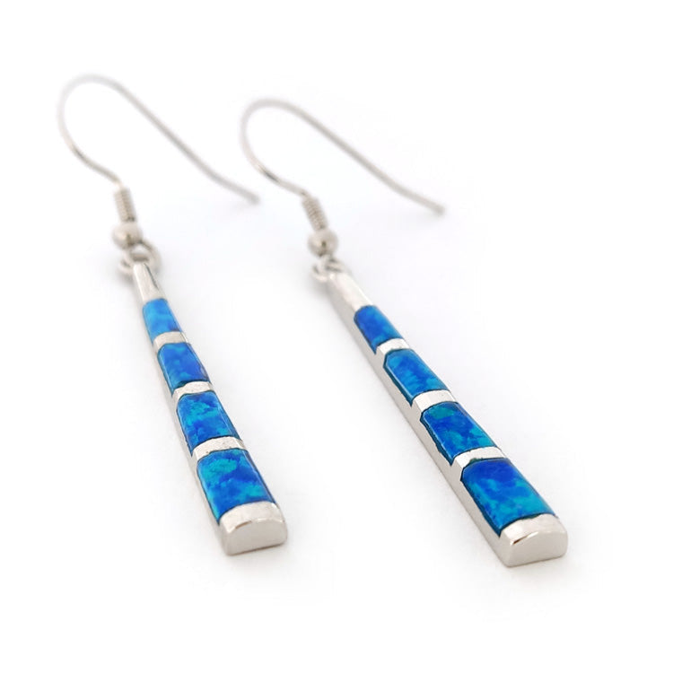 Pair of blue OPAL inlay SILVER DANGLE earrings on a white background