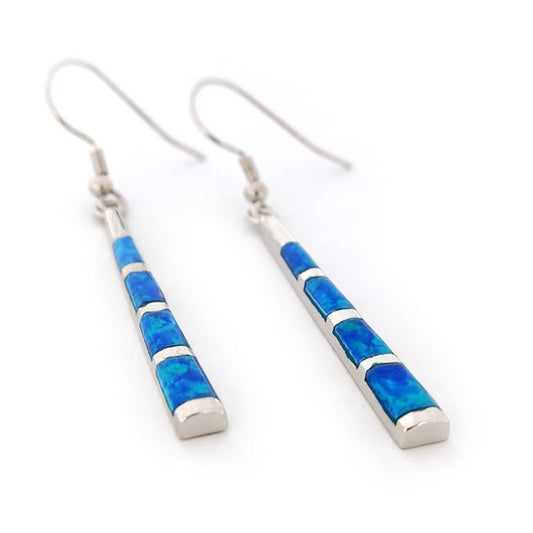 Pair of blue OPAL inlay SILVER DANGLE earrings on a white background
