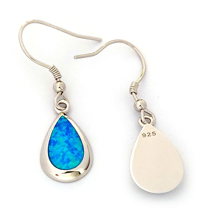 925 hallmark on silver earrings with blue opal stones on white background.