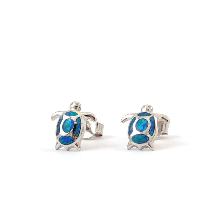 Turtle-shaped earrings with blue details on a white background