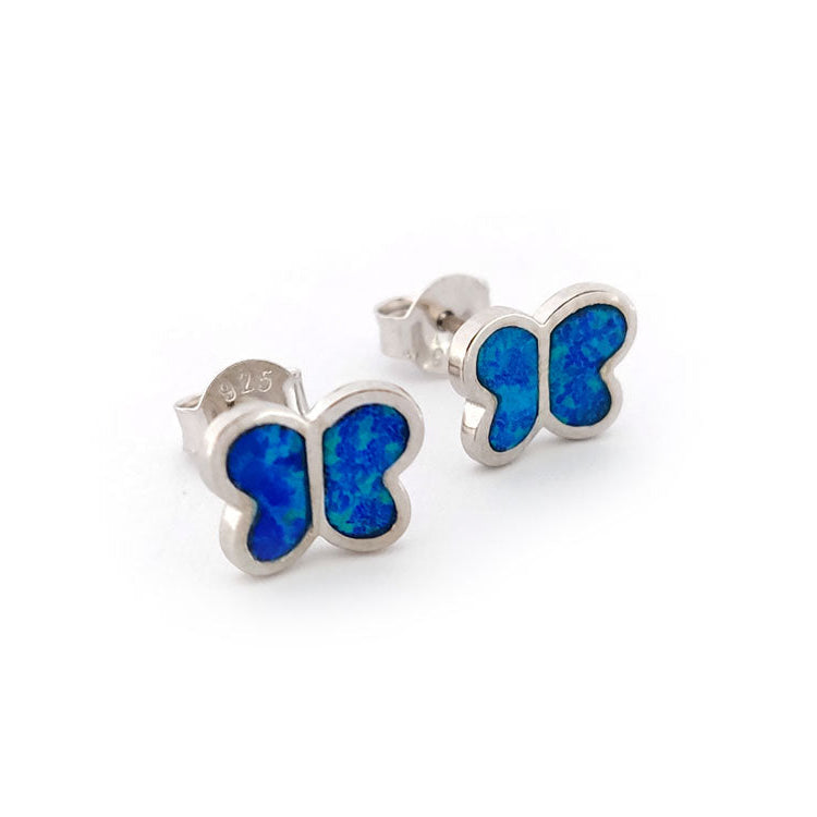 Butterfly-shaped earrings with blue centers on a white background