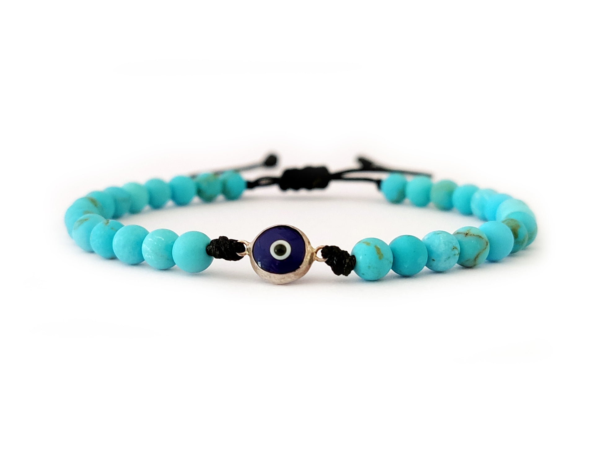 Close-up image of a Silver 925 Evil Eye Bracelet with a 6 mm Evil Eye charm, 4 mm Natural Turquoise stones, and a Slide Macrame Clasp. Handcrafted in Greece, this bracelet combines elegance and protective symbolism, making it a unique and meaningful addition to your jewelry collection.