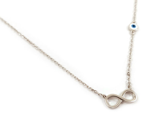 Sterling silver 925 infinity necklace with evil eye pendant on a white background. The infinity symbol measures 13 x 6 mm, and the evil eye design is 5 mm. Adjustable necklace length: 40-43 cm. Made in Greece. Free shipping worldwide.