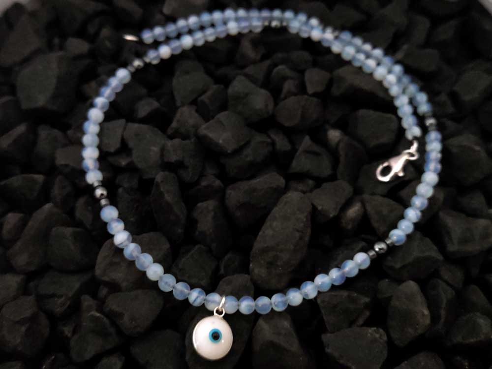 Handmade Sterling Silver Evil Eye Pendant with 4mm Moonstone and Hematite Beads, featuring a silver and white enamel Evil Eye design, 10mm wide, made in Greece.