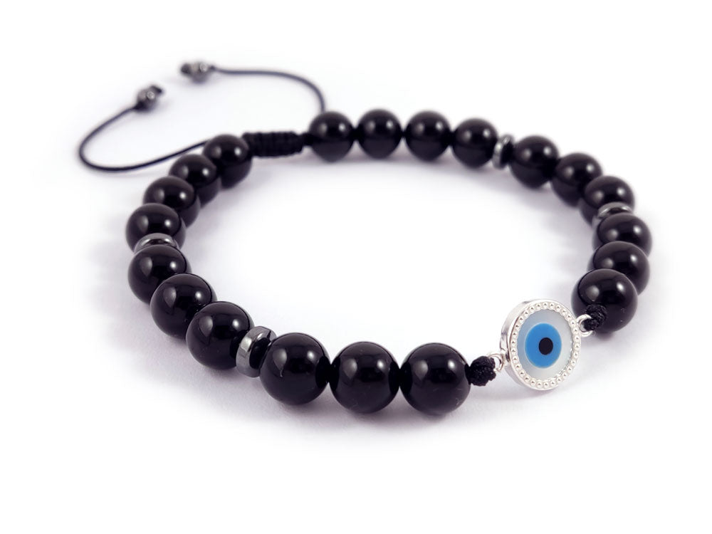 "Sterling Silver 925 bracelet with a Mother of Pearl Evil Eye (10mm) and natural 8mm onyx black stones, finished with a slide clasp. Handmade in Greece with hallmark 925 and free global shipping."

