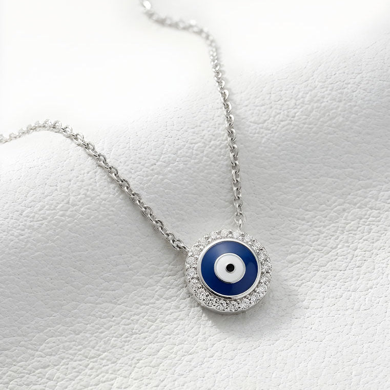 Necklace with a blue evil eye pendant on a white background