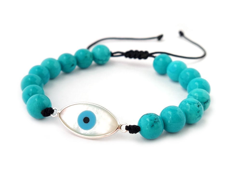 Silver Evil Eye with turquoise stones measuring 8mm and with slide clasp. made in Greece and placed on white background.