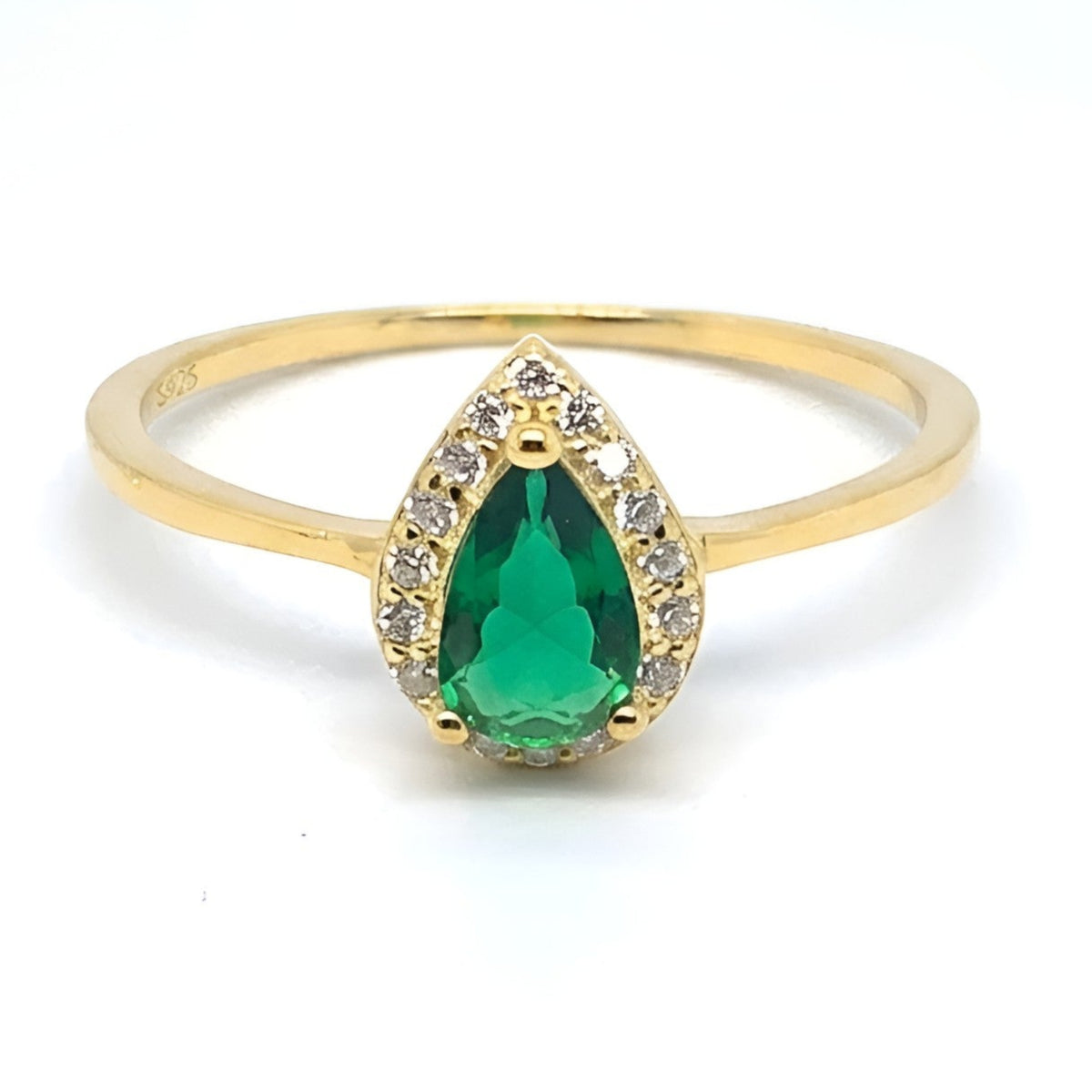 A yellow gold ring featuring a pear-cut green emerald gemstone surrounded by small clear accent stones, set on a plain white background.