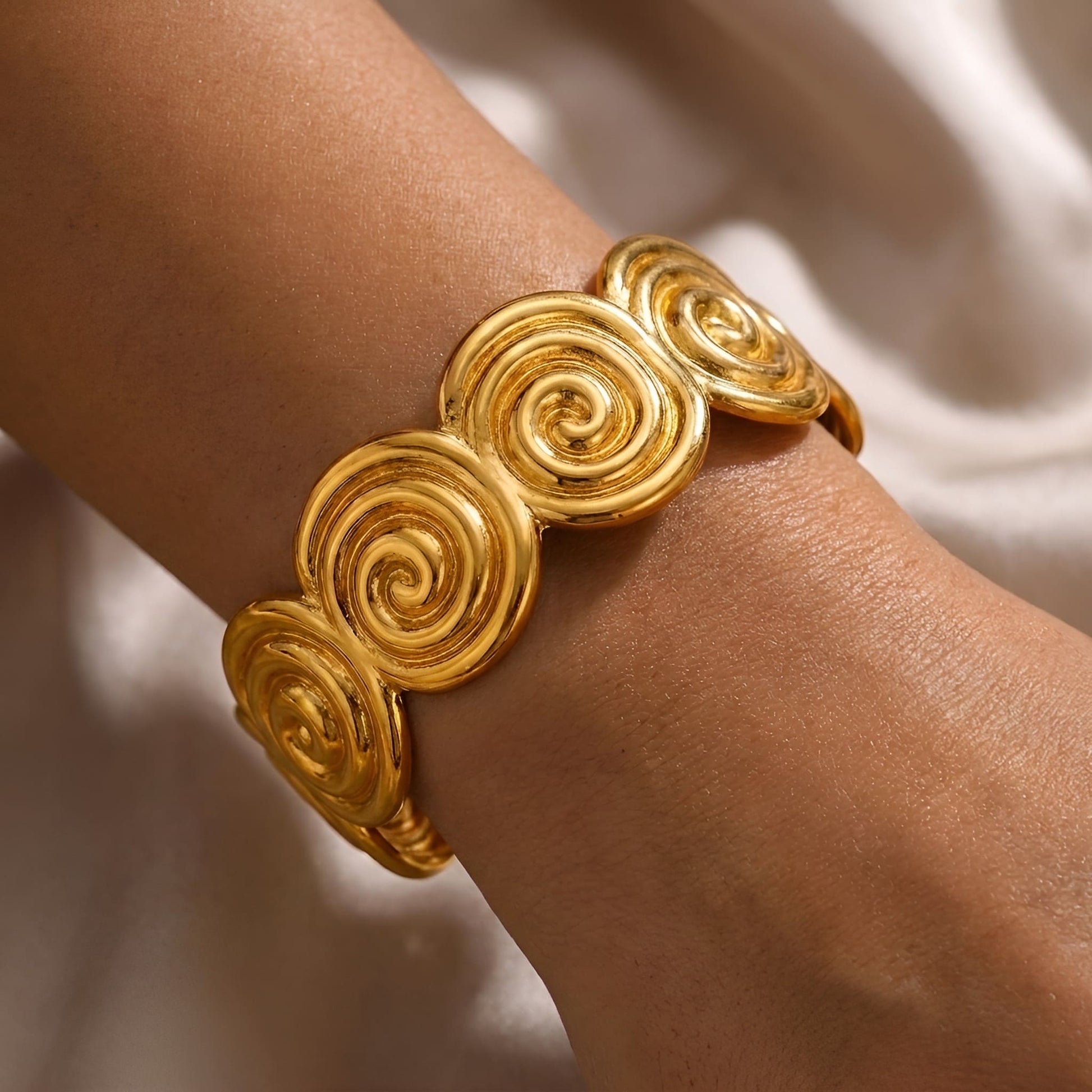Gold plated stainless steel cuff bracelet with repeating Circle of Life motif