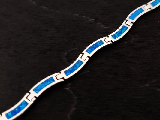 Blue opal silver adjustable wave pattern bracelet measuring 3mm width.