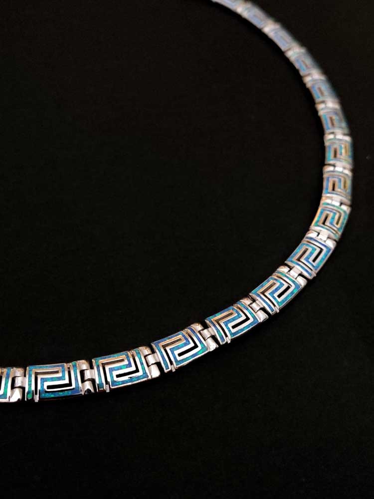 Close-up of a Sterling Silver 925 Fire Rainbow Blue Opal Necklace with a modern curved design, inspired by Greek key motif, symbolizing infinity and unity.