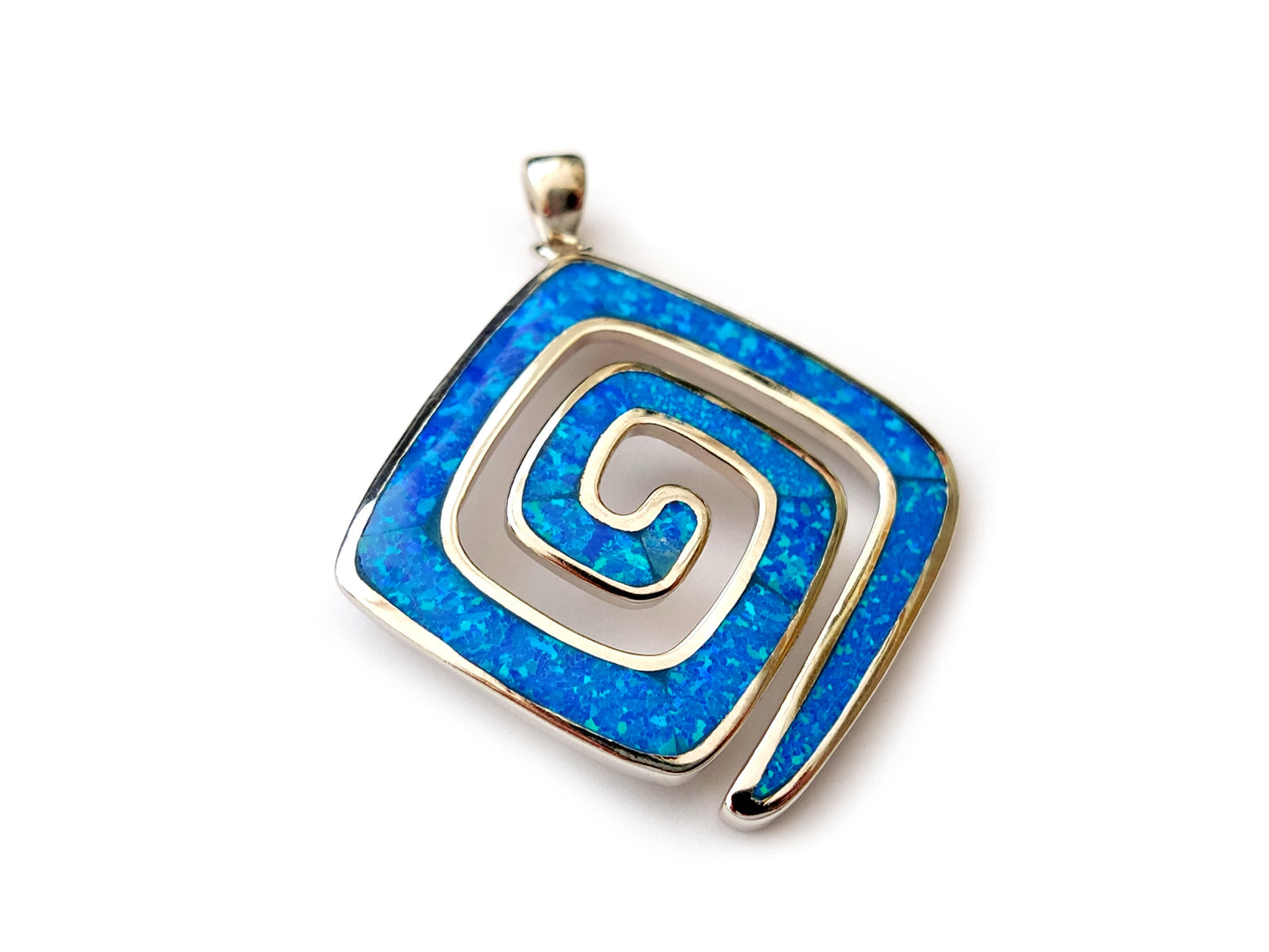 Greek Key Meander pendant made of sterling silver 925 and blue opal stones measuring 27mm placed on white background.