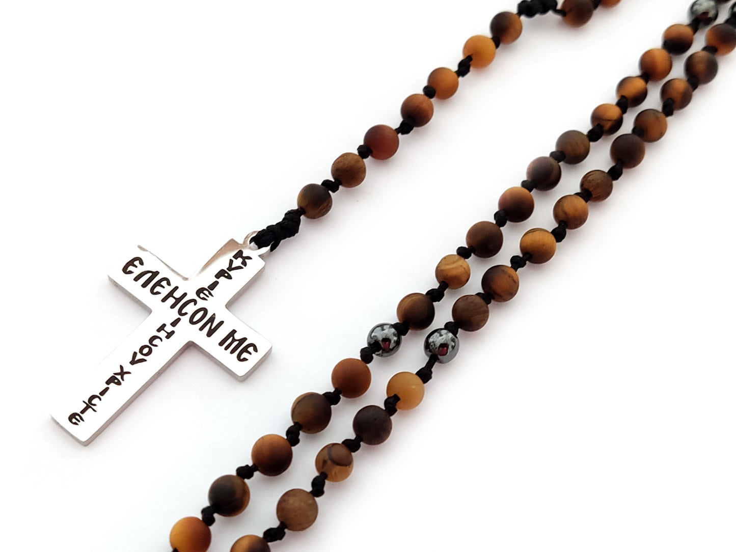 Greek cross necklace made of natural matt tiger's eye measuring 4mm in adjustable length. The cross is made of stainless steel with the words " Jesus Christ Show Mercy On Me". The necklace is handmade in Greece.