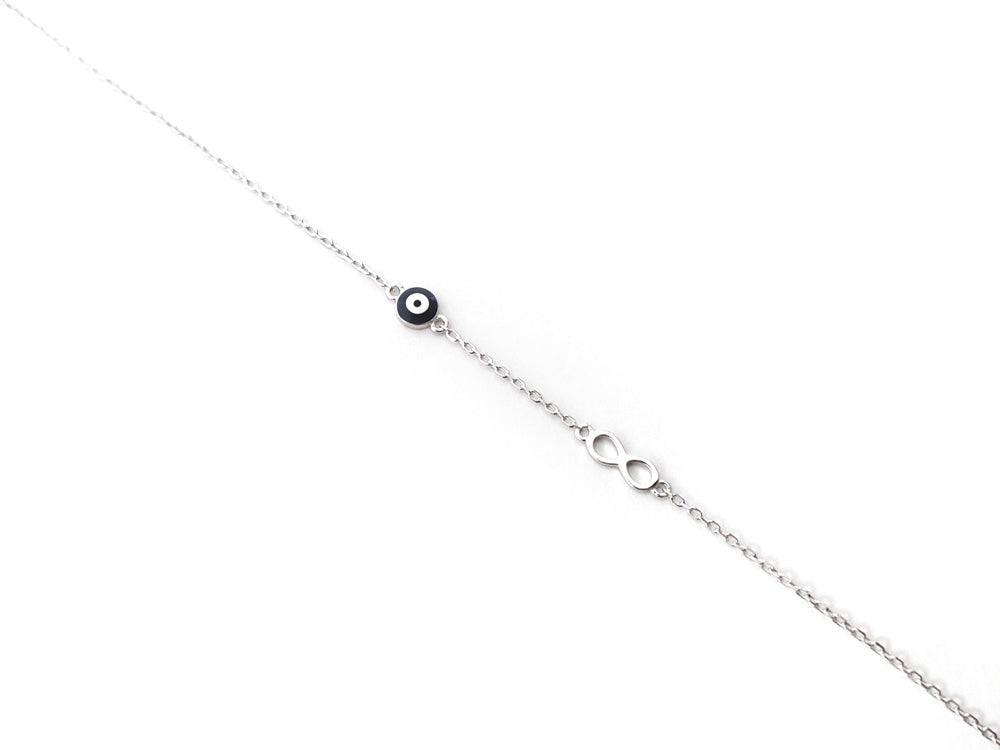 Close-up of adjustable 925 silver Greek bracelet with mati and infinity charm

