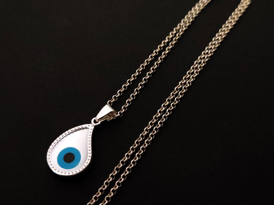 Close-up view of Greek Silver Mother Of Pearl Drop Evil Eye Pendant Necklace - Silver Evil Eye Jewelry.